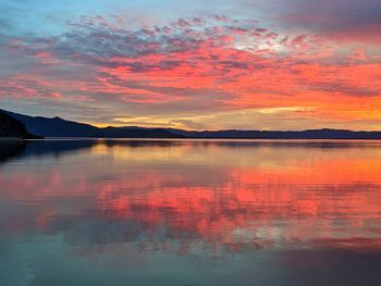 Scenic view of lake against romantic sky at sunset