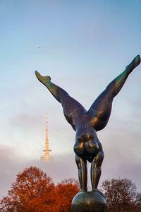 Low angle view of statue against sky