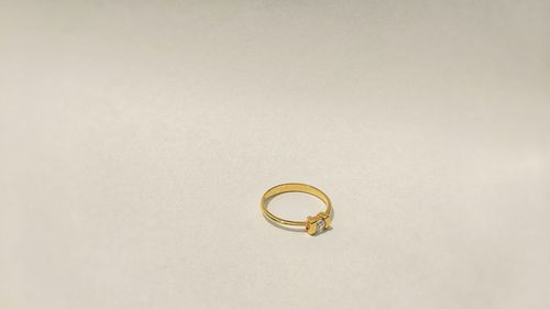 Close-up of wedding rings on metal against white background