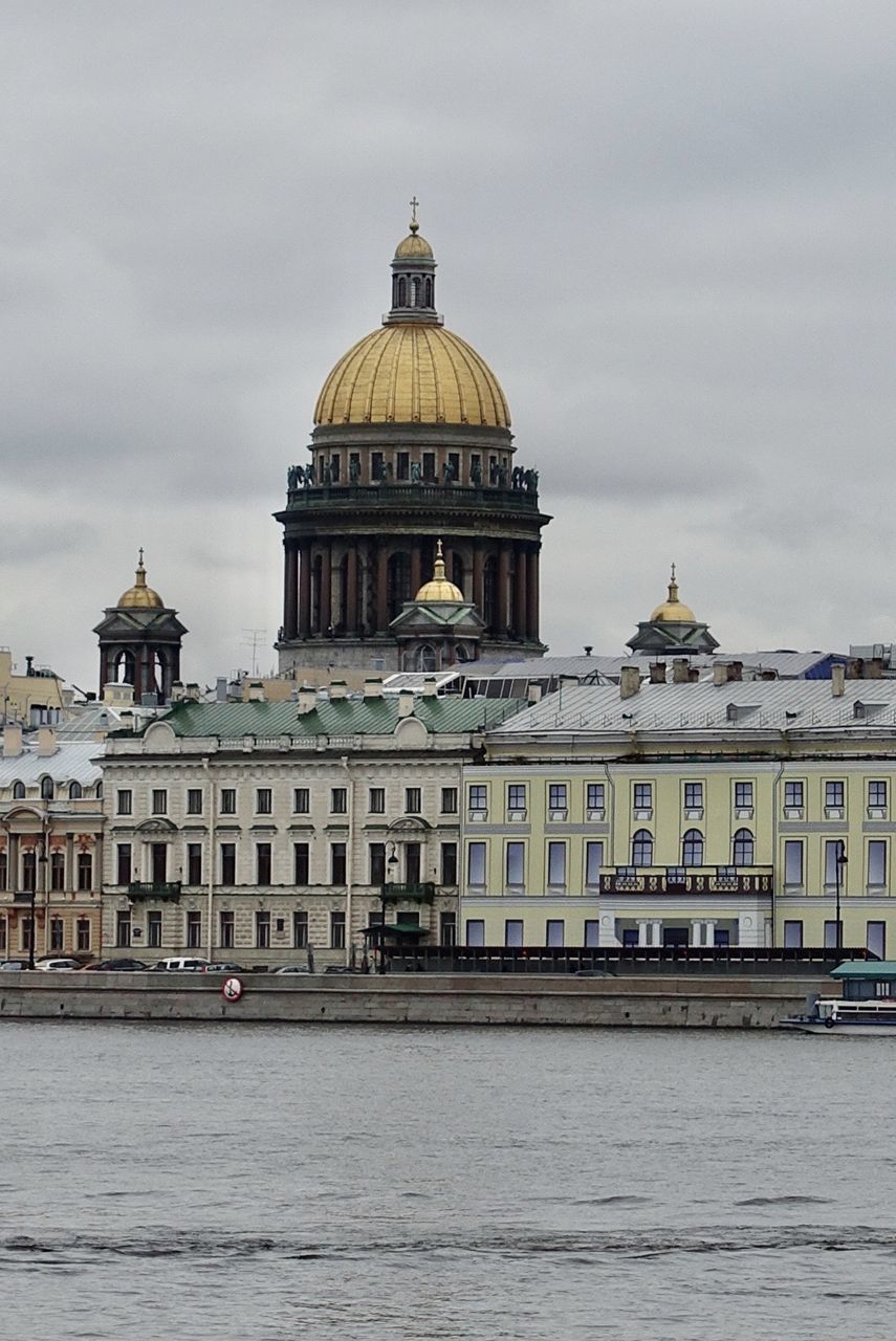 VIEW OF BUILDING AGAINST SKY WITH WATERFRONT