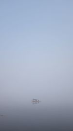 Boat sailing in sea against sky