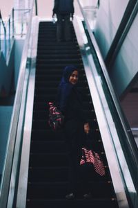 High angle view of people walking on steps at railroad station