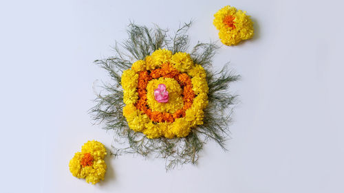 Close-up of yellow flower bouquet against white background