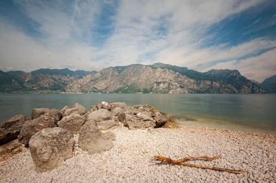 Scenic view of sea and mountains against sky