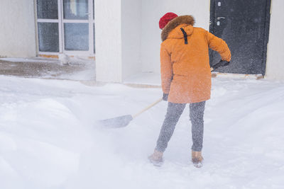 Full length of woman standing on snow