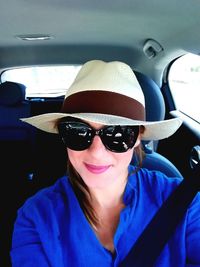 Portrait of a smiling young woman in car