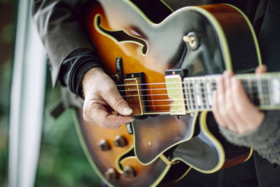 Close-up of man playing guitar 