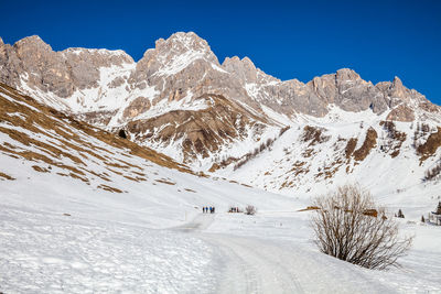 Scenic view of snow covered mountains against sky