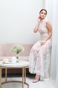 Portrait of woman sitting on table