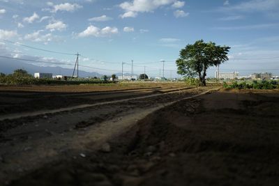 Railroad track against cloudy sky