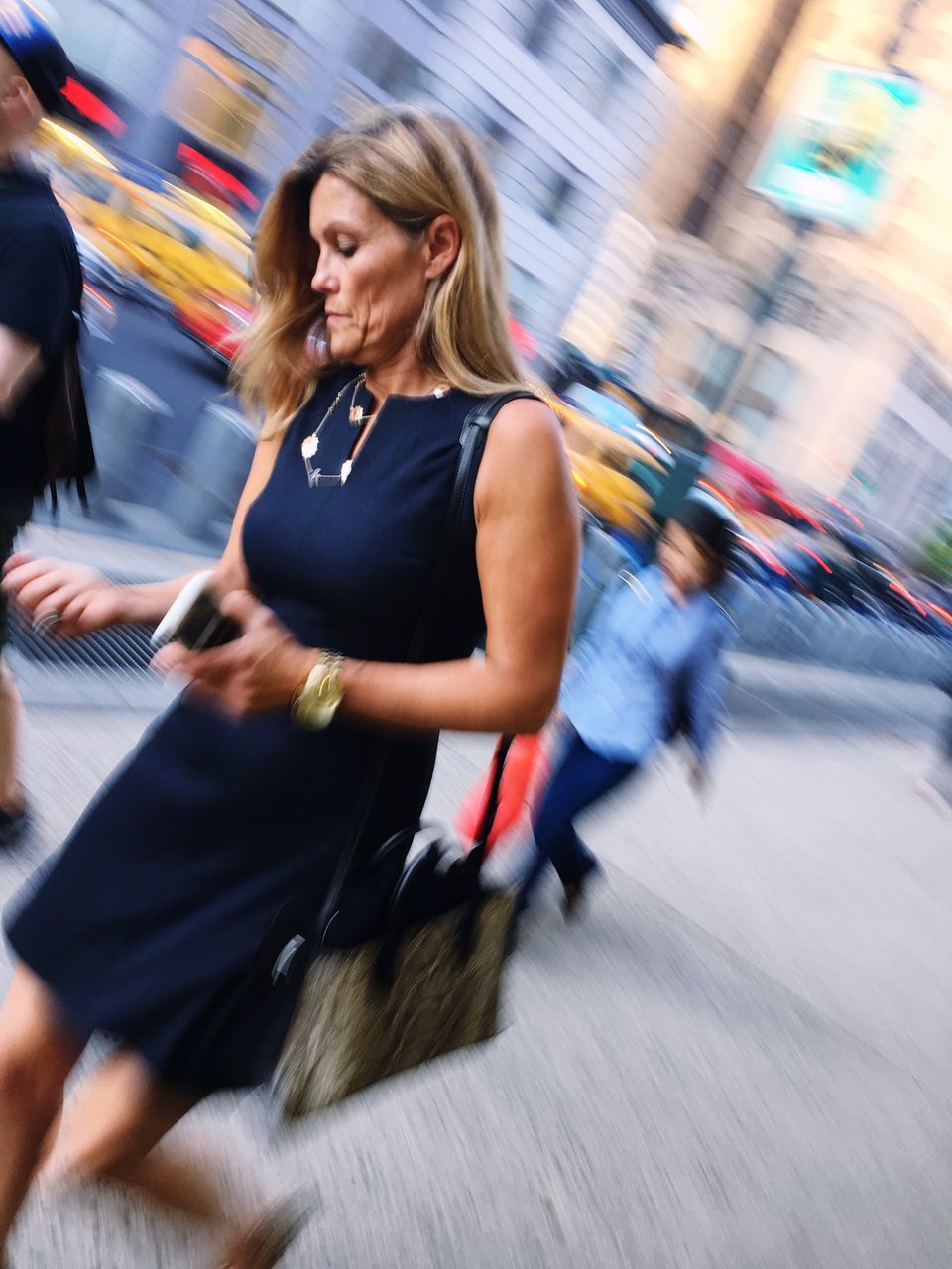 blurred motion, motion, real people, lifestyles, women, one person, adult, walking, speed, street, city, transportation, hair, casual clothing, architecture, blond hair, incidental people, young adult, outdoors, hairstyle, beautiful woman