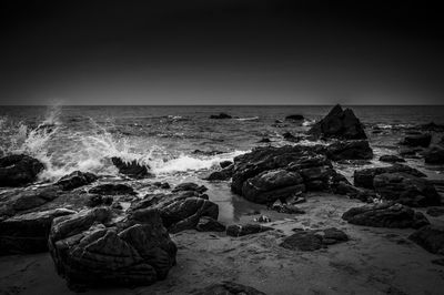 Waves splashing on rocks on shore