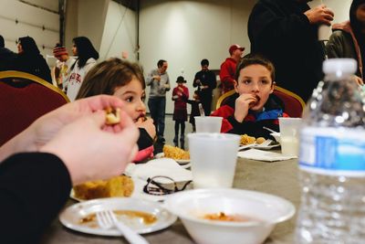 Family having food at table in restaurant