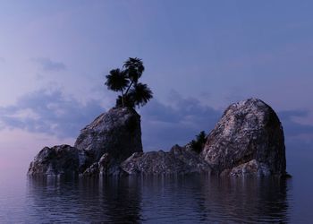 Rock formation in sea against sky