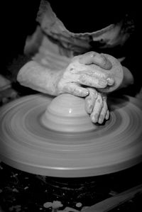 Midsection of person working in kitchen