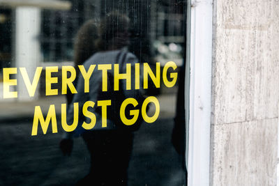 Close-up of yellow text on window