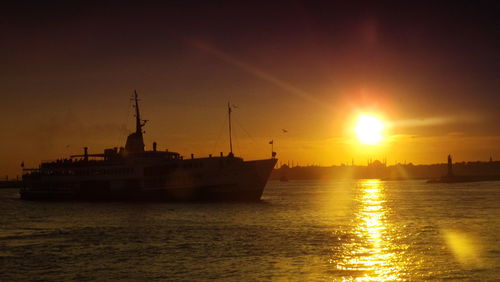 Boat in sea at sunset