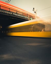 Blurred motion of yellow train against sky