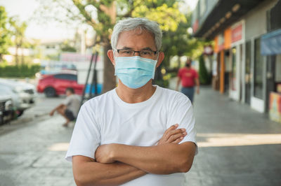 Portrait of man standing on street