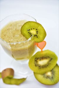 Close-up of fruits in glass over white background