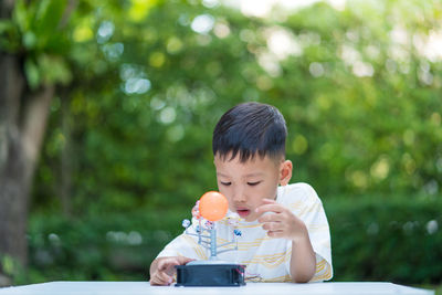 Boy holding ice cream cone outdoors