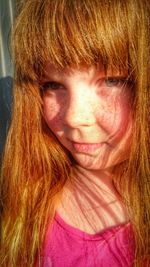 Close-up of cute redhead girl with bangs looking away at home