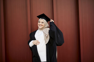 Smiling woman wearing graduation hat