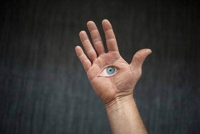 Close-up of human hand against black background