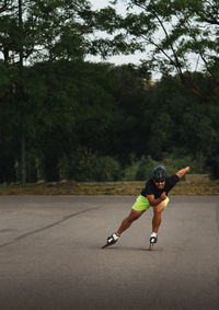 Full length of man inline skating on road