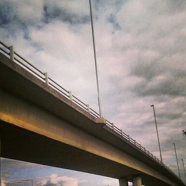 sky, cloud - sky, transportation, bridge - man made structure, cloudy, low angle view, built structure, connection, architecture, railing, engineering, cloud, bridge, mode of transport, overcast, travel, day, weather, outdoors, no people