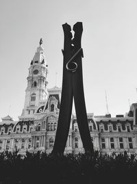 Low angle view of statue in city against clear sky