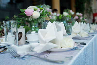 White roses in vase on table