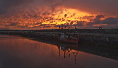 Scenic view of calm sea against cloudy sky