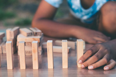 Close-up of hands playing on table