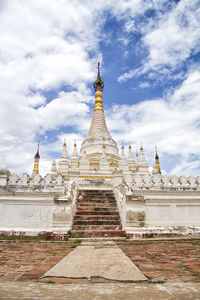 Low angle view of temple building against cloudy sky