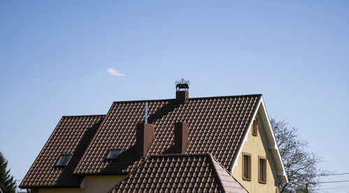 Low angle view of house roof against sky