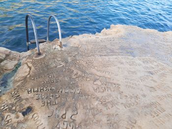 High angle view of text on beach