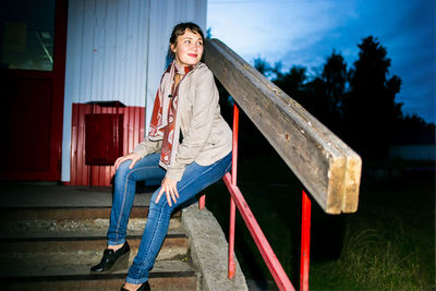 Portrait of young woman sitting outdoors