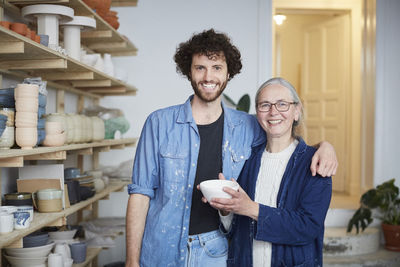 Portrait of smiling man and woman in pottery class