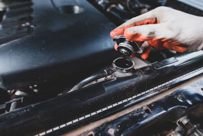 Mechanic repairing car engine in garage