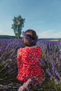 Rear view of woman with arms raised