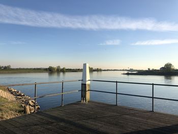 Pier over lake against sky