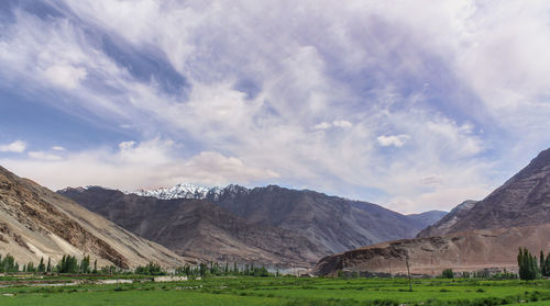 Scenic view of landscape and mountains against sky