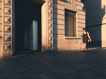 Woman standing outside building