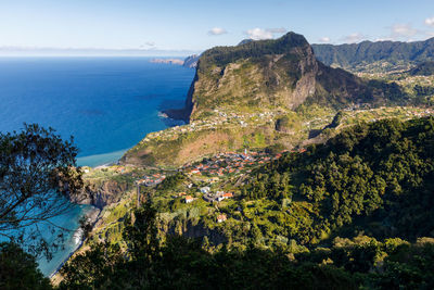 High angle view of trees and sea against sky