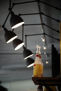 Low angle view of illuminated light bulbs hanging from ceiling