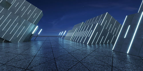 Low angle view of illuminated buildings against sky at night