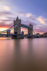 View of bridge over river against cloudy sky