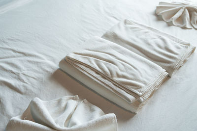 High angle view of towels on bed at hotel