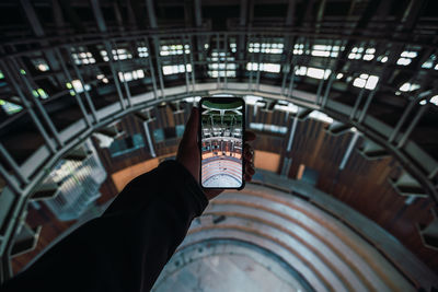 Reflection of person photographing through smart phone